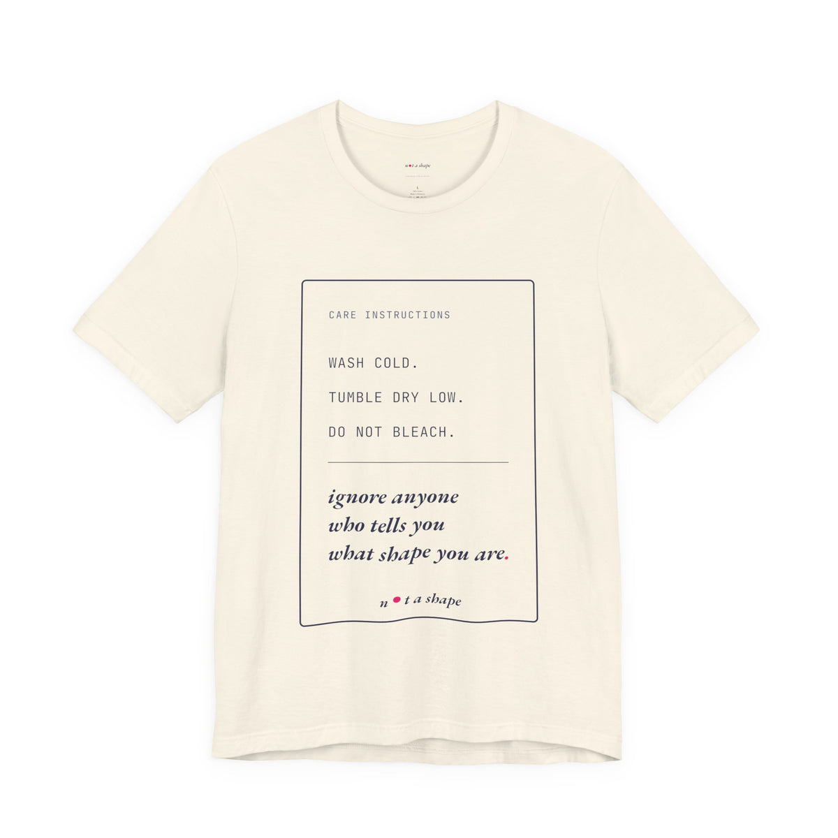 An off-white short-sleeve crewneck t-shirt with a printed care instructions graphic on the front, featuring text that reads 'WASH COLD. TUMBLE DRY LOW.