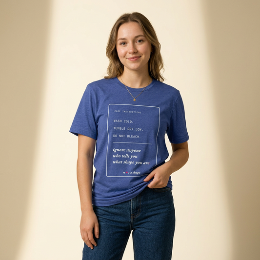 a woman modeling a blue t-shirt with a care label style graphic, wearing blue jeans