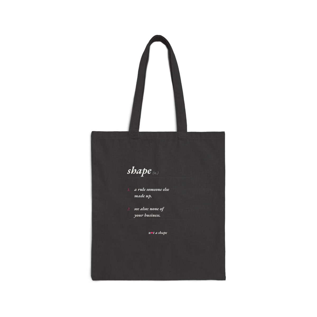 A black canvas tote bag with two black shoulder straps, featuring a white printed dictionary-style definition of the word 'shape' on the front. The bag is photographed against a clean, solid white background.